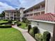 Condo building with manicured lawn and flower beds at 6505 Stone River Rd # 309, Bradenton, FL 34203