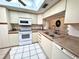 Bright kitchen with white cabinets, modern appliances and tile floors at 6505 Stone River Rd # 309, Bradenton, FL 34203
