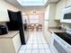 Kitchen with white cabinetry, tile floors and view to breakfast area at 6505 Stone River Rd # 309, Bradenton, FL 34203