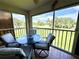View of the patio space with seating and view of the yard at 6505 Stone River Rd # 309, Bradenton, FL 34203