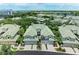 Aerial shot showcasing townhome-style condos with lush landscaping and convenient garage parking at 6536 Moorings Point Cir # 101, Lakewood Ranch, FL 34202