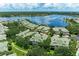 Aerial view of the community featuring well-maintained homes and a beautiful lake at 6536 Moorings Point Cir # 101, Lakewood Ranch, FL 34202