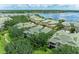 A stunning aerial view of a lakeside community with lush greenery and well-maintained homes at 6536 Moorings Point Cir # 101, Lakewood Ranch, FL 34202