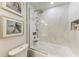 Modern bathroom with glass-enclosed shower, marble accents, and a luxurious bathtub at 6536 Moorings Point Cir # 101, Lakewood Ranch, FL 34202