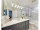 Elegant bathroom featuring modern vanity, stylish lighting, and a shower-tub combination at 6536 Moorings Point Cir # 101, Lakewood Ranch, FL 34202