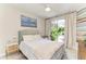 Bright bedroom with natural light, neutral tones, and sliding glass doors to the outside at 6536 Moorings Point Cir # 101, Lakewood Ranch, FL 34202