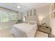 Well-lit bedroom with large windows, a ceiling fan, and neutral decor at 6536 Moorings Point Cir # 101, Lakewood Ranch, FL 34202