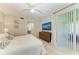Bedroom with a large window, ceiling fan, neutral decor, and an en suite bathroom at 6536 Moorings Point Cir # 101, Lakewood Ranch, FL 34202