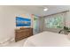 Bedroom with a large window, ceiling fan, neutral decor, and an en suite bathroom at 6536 Moorings Point Cir # 101, Lakewood Ranch, FL 34202