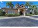 Attractive one-story building with lush landscaping, elegant entrance, and a warm, inviting facade at 6536 Moorings Point Cir # 101, Lakewood Ranch, FL 34202