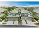 An inviting shot of the home's facade, featuring a two-car garage, lush landscaping, and a welcoming entryway at 6536 Moorings Point Cir # 101, Lakewood Ranch, FL 34202