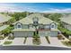 An inviting shot of the home's facade, featuring a two-car garage, lush landscaping, and a welcoming entryway at 6536 Moorings Point Cir # 101, Lakewood Ranch, FL 34202