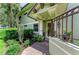 A well-decorated doorway with plants that creates an inviting front entrance at 6536 Moorings Point Cir # 101, Lakewood Ranch, FL 34202