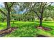 View of the well-maintained green spaces with mature trees and landscaping throughout the community at 6536 Moorings Point Cir # 101, Lakewood Ranch, FL 34202