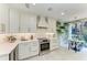 A modern kitchen featuring white cabinets, quartz counters, and stainless steel appliances at 6536 Moorings Point Cir # 101, Lakewood Ranch, FL 34202