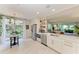 Bright kitchen with stainless appliances, white cabinets, and backyard view at 6536 Moorings Point Cir # 101, Lakewood Ranch, FL 34202