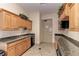 Functional kitchen featuring wood cabinets, granite countertops, stainless steel appliances, and ample storage space at 6536 Moorings Point Cir # 101, Lakewood Ranch, FL 34202