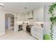 Bright kitchen with stainless appliances, white cabinets, wine cooler, and quartz countertops at 6536 Moorings Point Cir # 101, Lakewood Ranch, FL 34202