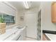 Bright laundry room features modern LG washer and dryer and ample natural light from the window at 6536 Moorings Point Cir # 101, Lakewood Ranch, FL 34202