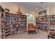 Inviting library featuring floor-to-ceiling bookshelves filled with books and comfortable seating at 6536 Moorings Point Cir # 101, Lakewood Ranch, FL 34202