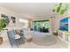 A comfortable living room featuring a neutral color palette and a sliding glass door to the outdoor space at 6536 Moorings Point Cir # 101, Lakewood Ranch, FL 34202