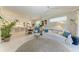 Bright living room with an area rug, comfortable sofa, and easy access to the kitchen and dining area at 6536 Moorings Point Cir # 101, Lakewood Ranch, FL 34202