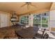 Outdoor kitchen and dining area with stainless steel grill, comfortable seating, and screened-in patio at 6536 Moorings Point Cir # 101, Lakewood Ranch, FL 34202