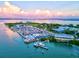 Expansive aerial view showcasing a marina, waterfront restaurants, and surrounding coastal landscape at 701 Marbury Lane, Longboat Key, FL 34228