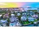 Beautiful aerial view showcasing waterfront homes with pools, private docks, and lush landscaping under a vibrant sky at 701 Marbury Lane, Longboat Key, FL 34228