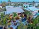 Aerial view showcasing a house with a refreshing backyard pool surrounded by palm trees at 701 Marbury Lane, Longboat Key, FL 34228