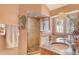 Elegant bathroom with a frameless glass shower, stone floors, and a custom vanity with sink offering spa-like experience at 701 Marbury Lane, Longboat Key, FL 34228