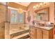 Luxurious bathroom featuring a soaking tub with stone accents, double vanity, and natural light creating a relaxing retreat at 701 Marbury Lane, Longboat Key, FL 34228
