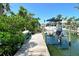 Private boat dock with a boat lift offering convenient access to waterways at 701 Marbury Lane, Longboat Key, FL 34228