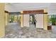 Open carport area featuring durable gray tiled flooring and ample space for parking and outdoor activities at 701 Marbury Lane, Longboat Key, FL 34228