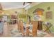 Open concept dining room featuring wood table, vaulted ceiling, and adjoining kitchen at 701 Marbury Lane, Longboat Key, FL 34228