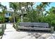 A calming view of a dockside bench with a view of a home at 701 Marbury Lane, Longboat Key, FL 34228
