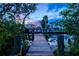 Picturesque dock with charming details and a tranquil view of the water at sunset at 701 Marbury Lane, Longboat Key, FL 34228