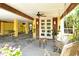 Covered ground floor featuring a seating area, ceiling fan, and a welcoming front door at 701 Marbury Lane, Longboat Key, FL 34228