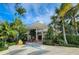 Unique commercial building surrounded by lush tropical landscaping and palm trees at 701 Marbury Lane, Longboat Key, FL 34228