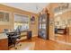 Home office featuring a work desk, bookcase, and hardwood floors, offering a functional and stylish workspace at 701 Marbury Lane, Longboat Key, FL 34228
