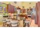 Bright kitchen featuring granite countertops, breakfast bar and stainless steel appliances at 701 Marbury Lane, Longboat Key, FL 34228