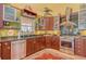 Gourmet kitchen with stainless steel appliances, granite countertop, and ample cabinet space at 701 Marbury Lane, Longboat Key, FL 34228