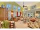 Spacious living room with high ceilings, many windows, and cozy furnishings at 701 Marbury Lane, Longboat Key, FL 34228