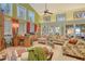 Bright living room with high ceilings, a ceiling fan, and comfortable seating, creating an inviting atmosphere at 701 Marbury Lane, Longboat Key, FL 34228