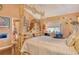 Cozy bedroom featuring a unique bamboo canopy bed, wood floors, and ample natural light creating a peaceful atmosphere at 701 Marbury Lane, Longboat Key, FL 34228