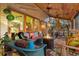 Spacious screened patio featuring a fire pit, comfortable wicker seating, and tropical views at 701 Marbury Lane, Longboat Key, FL 34228