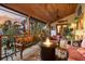 Inviting screened patio with a warm fire pit, plush seating, and serene backyard ambiance at 701 Marbury Lane, Longboat Key, FL 34228