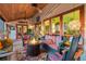 Comfortable screened patio with fire pit, cushioned seating, and relaxing outdoor space at 701 Marbury Lane, Longboat Key, FL 34228