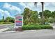 Signage for 'Centre Shops' plaza, showcasing a variety of businesses in a tropical setting at 701 Marbury Lane, Longboat Key, FL 34228