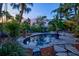 Serene backyard pool area surrounded by lush landscaping and comfortable lounge chairs for relaxation at 701 Marbury Lane, Longboat Key, FL 34228